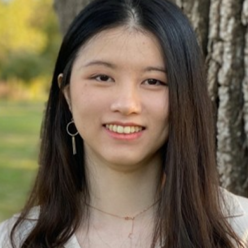 Asian female with long dark hair wearing beige shirt