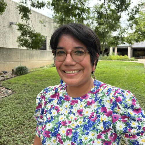 image of Delyla Ovalle wearing glasses and flower dress