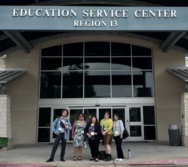 : image of the TX-ADDM team standing outside of the Region 13 Education Service Center in business casual attire.